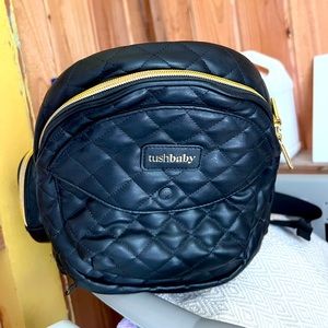 Tushbaby carrier in black faux leather and gold hardware